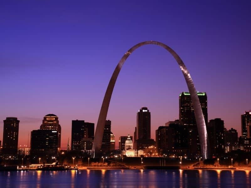 St. Louis skyline at dusk featuring the Gateway Arch, downtown buildings, and riverfront views for St. Louis land surveying services